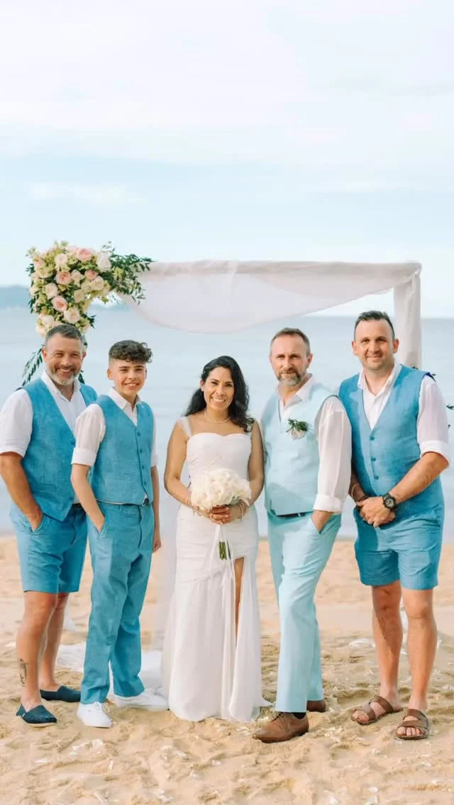 #wedding ! The wedding suit worn by the groom (center, holding hands with the bride) is a light blue three-piece suit, which includes:
	•	A light blue vest and matching trousers
	•	A white shirt (no tie, creating a relaxed beach vibe)
	•	A boutonnière (flower pin) on the left lapel, adding a romantic touch

This outfit is perfect for a beach wedding—it’s stylish, light, and fits the tropical setting beautifully. If you’re looking for something similar or want suggestions based on this style (tailoring, colors, fabrics), feel free to ask!